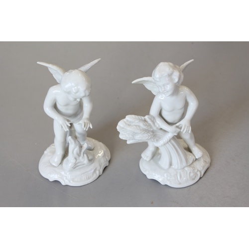 137 - A Pair of Dresden white glazed cupid ornaments.
