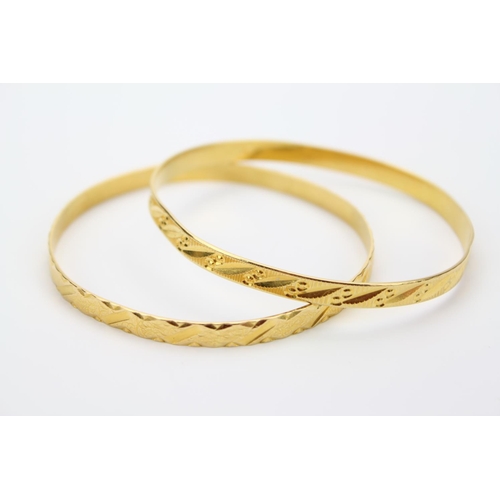 88 - A Ladies 21ct Gold Bangle Decorated with Flowers along with one other decorated Similarly. Marked M.... 