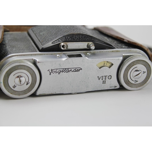 551 - A Rollex Patent Twin Film Drop Flap Roll Action Box Camera in Leather Case and a Voigtlander Vito Nu... 