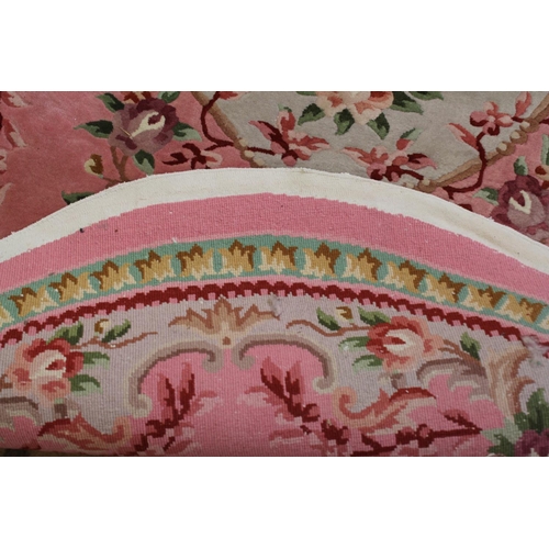 296 - A Lovely Oval Washed Chinese Rug in a Floral Pink Design. Measuring: 288cms long x 193cms Wide.