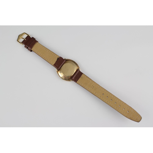 194 - A 9ct Gold Omega Watch in Oval Shape with a Black Face & Brown Leather Strap.