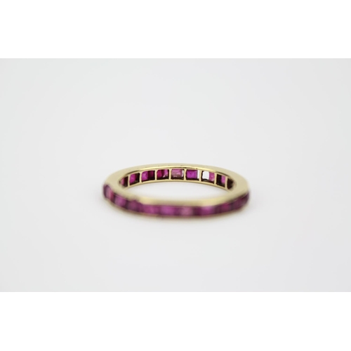 114 - A Ladies Gold Ring set with a line of Ruby's. Size: k.