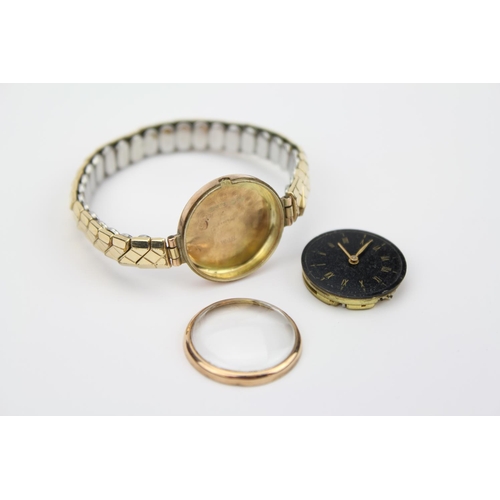 164 - A 9ct Gold cased swiss made wristwatch with a black face.