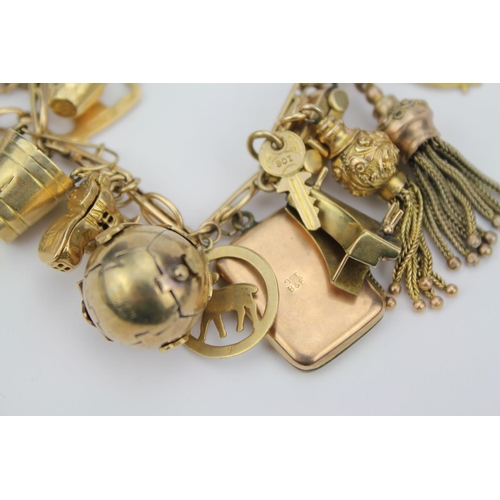 105 - A 9ct Gold Charm Bracelet to include: Moby Dick, Old Shoe, Camera, Car, Masonic ball cross, Bucket. ... 