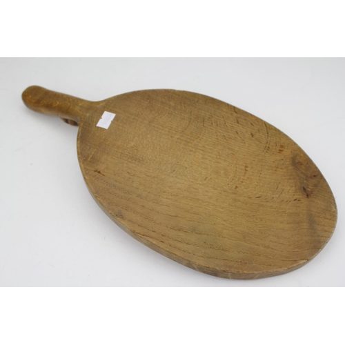 449 - A Mouse man oval cheeseboard with handle in oak by Robert Thompson.