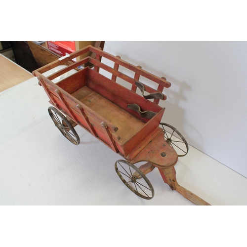 5 - A Late 19th Century Design Pell-Along Hay Cart resting on Metal Wheels. Total Length: 102cms.