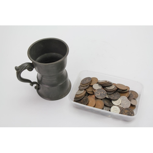 200 - A pewter Mug along with a quantity of coins.