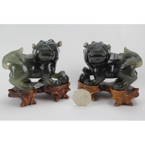134 - A Scarce Pair of Chinese Green carved Jade male Kylin's standing on wood bases.