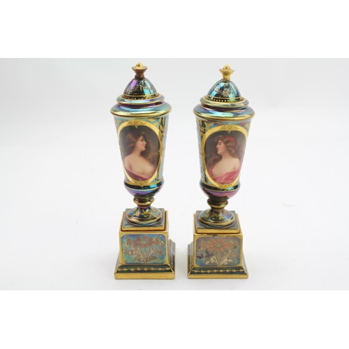 313 - A Pair of Royal Vienna design green lustre and gold vases painted with scenes of women.