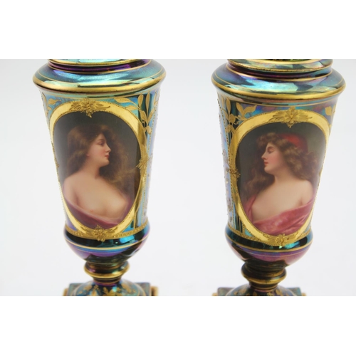 313 - A Pair of Royal Vienna design green lustre and gold vases painted with scenes of women.