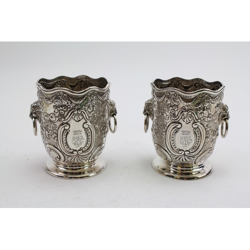 17 - A pair of silver miniature lion handled wine coolers with embossed decoration, Gold smiths and silve... 