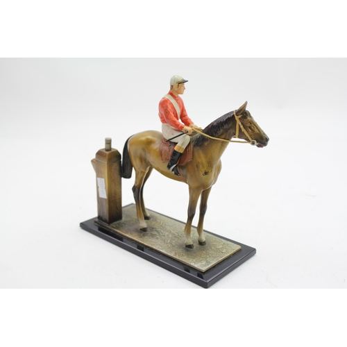 87 - A coloured spelter table lighter designed as a brown horse with jockey white trousers, red top white... 