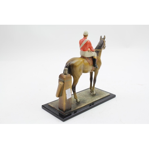 87 - A coloured spelter table lighter designed as a brown horse with jockey white trousers, red top white... 