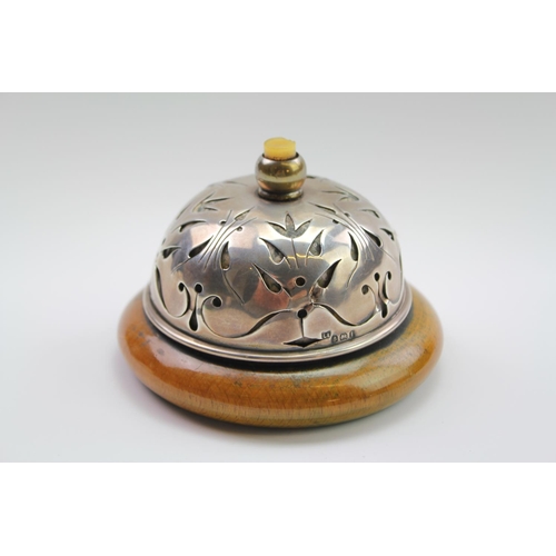34 - A late 19th century Silver mounted table bell, with turned knop, resting on a chestnut base, Birming... 