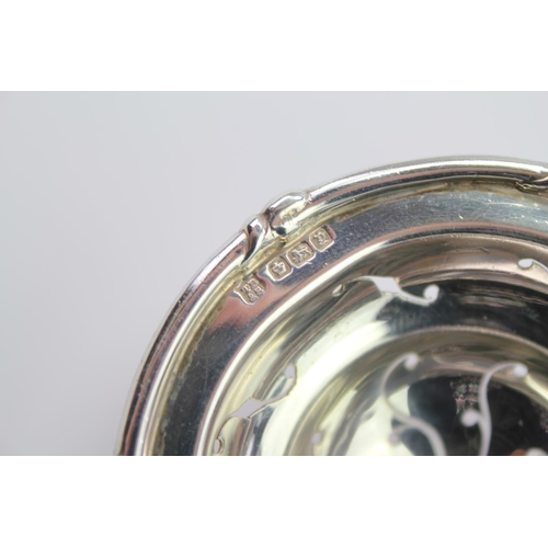 15 - A Silver Marked Tea Strainer, mounted with a mother of pearl handle, marked TB & S.