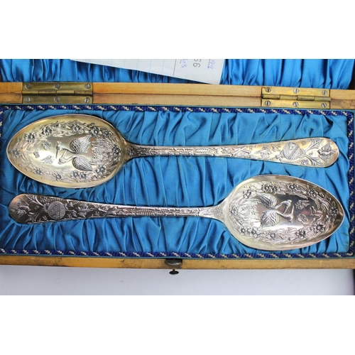 48 - A Cased Pair of Silver plated embossed berry spoons along with a cased set of French cutlery.