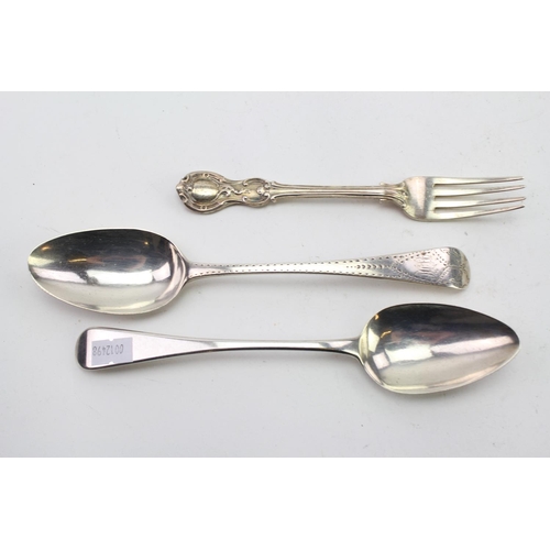 22 - Two Silver Georgian Desert Spoons, one bright cut and engraved and a similar fork. Weight approx: 18... 