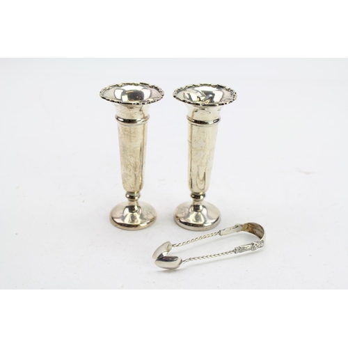 23 - A Pair of Silver spill vases, a pair of sugar tongs and a two handled sugar bowl.