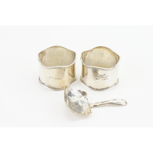 29 - A Georgian Silver Caddy Spoon & two Napkin Rings. Weighing: 66 grams.