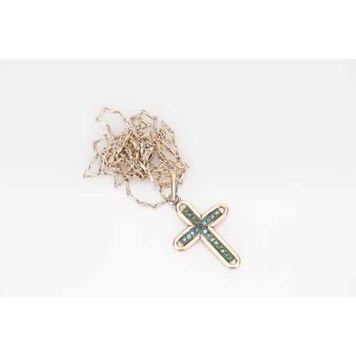 47 - A Gold coloured Turquoise Cross pendant hung on a gold coloured chain.