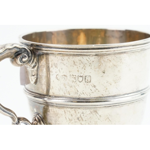 22 - A Silver Single Handled Mug with a Flying Scroll Handle. London U. Weighing: 173 grams.