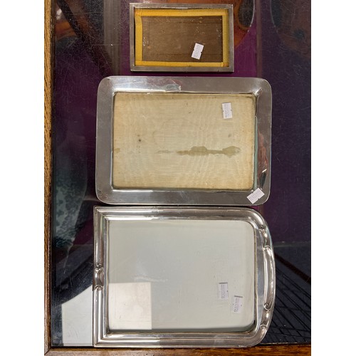 23 - Two Silver Photograph Frames with scrolling decoration & Plain along with one other Silver square.
