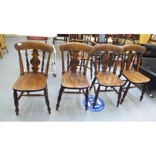 3 - A set of four late Victorian beech and elm framed Windsor chairs, each with a spindled and roundel s... 