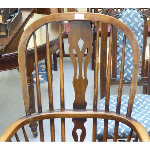 6 - A 19thC Windsor beech and elm framed high hoop, spindled and splat back arm chair, the solid seat ra... 