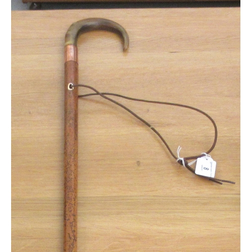 8 - A late 19thC Malacca walking cane with a horn crook handle, rose coloured metal ferrule and an eyele... 