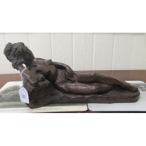 8 - B G Harrison (after Manon) - a cast and patinated bronze figure, a reclining nude  bears a signature... 