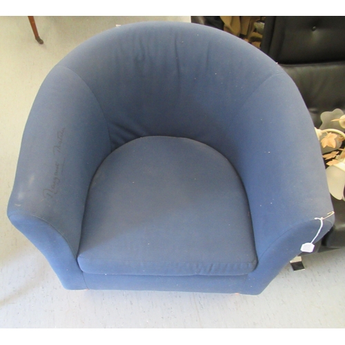17 - A modern tub style chair, upholstered in navy blue fabric with a cushion seat, raised on turned beec... 