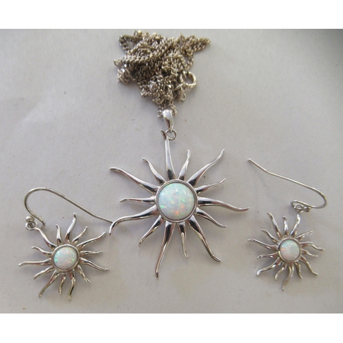 22 - A pair of silver coloured metal 'sun' design, opal set earrings and a matching pendant