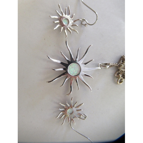 22 - A pair of silver coloured metal 'sun' design, opal set earrings and a matching pendant