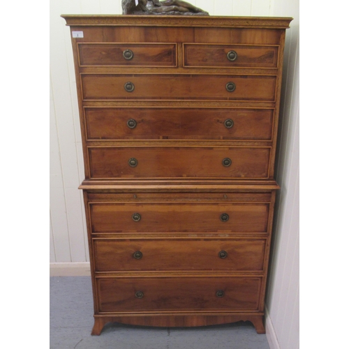3 - A modern reproduction of a 19thC yewwood finished tallboy, comprising two short/over seven graduated... 