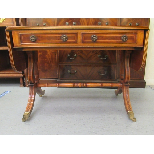 32 - A modern reproduction of a 19thC yewwood finished sofa table with two inline drawers and two facsimi... 