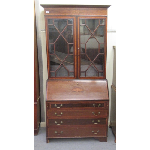 44 - An Edwardian and string inlaid mahogany bureau bookcase with an astragal glazed and shelved upper pa... 