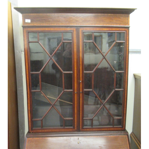 44 - An Edwardian and string inlaid mahogany bureau bookcase with an astragal glazed and shelved upper pa... 