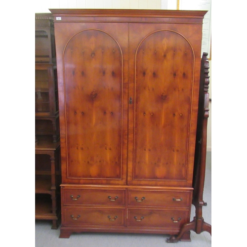 56 - A modern reproduction of a 19thC yewwood finished linen press, comprising a pair of doors, enclosing... 