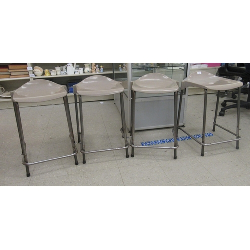 19 - A set of four mid/late 20thC Steelux London, GLC Design tubular steel framed work stools with moulde... 