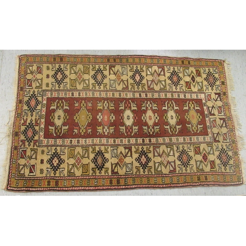 48 - A patterned wool rug with geometric ornament, on an iron red ground  60