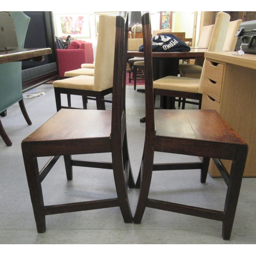 43 - A pair of mid/late 19thC oak framed pierced splat back dining chairs, the solid seats raised on squa... 