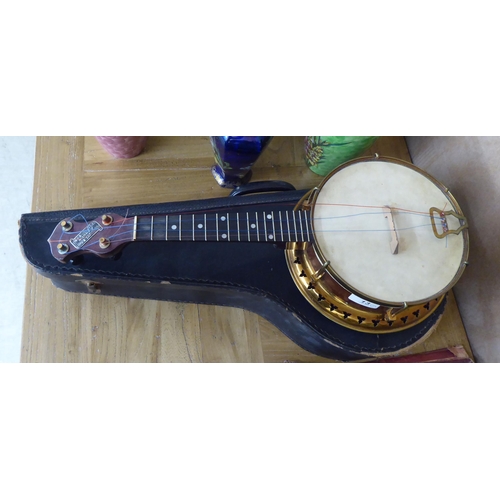 13 - A Sunray hardwood and gilt metal ukulele  cased 