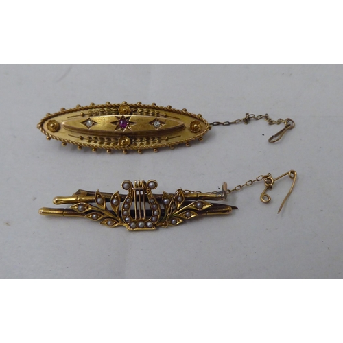 14 - Two late Victorian/Edwardian 15ct gold bar brooches, variously set with seed pearls and coloured sto... 