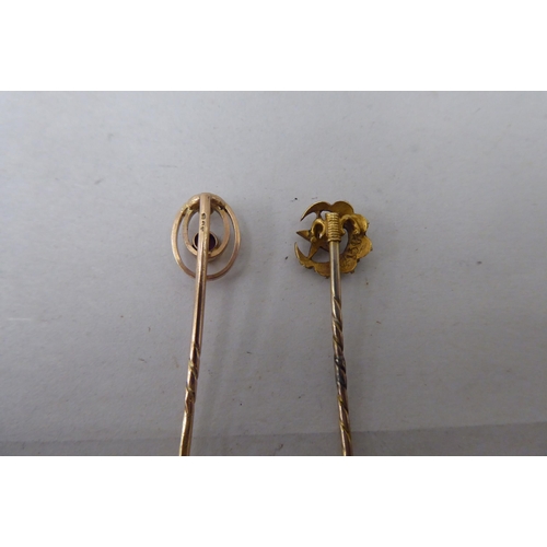 20 - Five dissimilar gold and yellow metal stickpins: to include an 18ct gold example, incorporating a ho... 