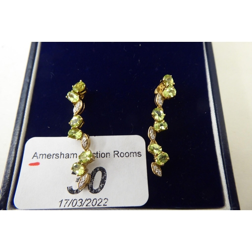 30 - A pair of 9ct gold peridot and white stone pendant earrings 