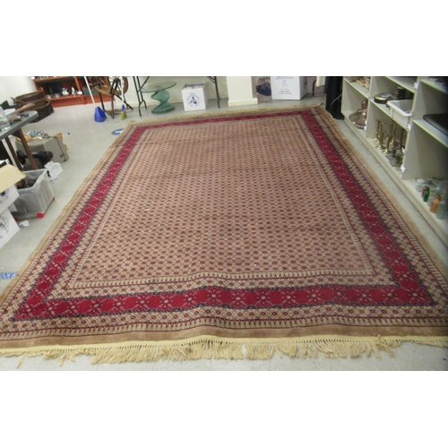 37 - A Turkish machine made carpet, decorated with traditional designs, on a multi-coloured ground  ... 