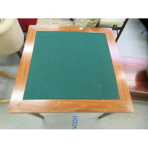 38 - A modern Eastern fruitwood bridge table with a green baize top, raised on folding square, tapered le... 