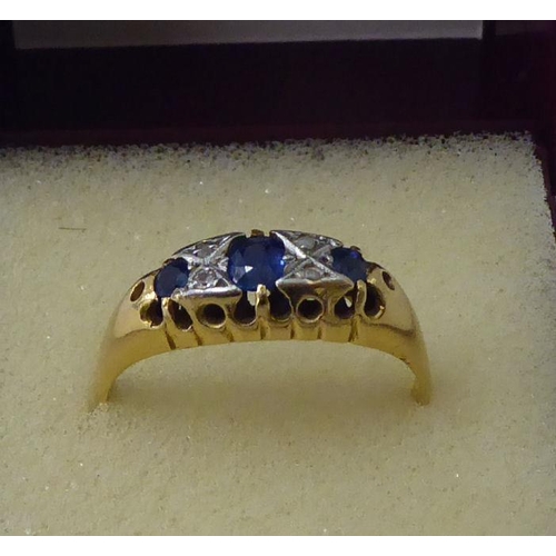 42 - An 18ct gold sapphire and white stone ring 