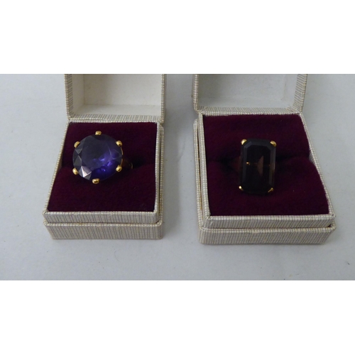 46 - Two Bahrainian yellow metal rings, one set with a smokey quartz, the other an amethyst coloured ston... 