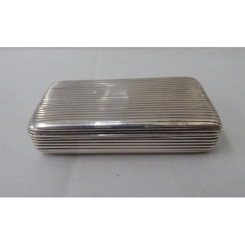 56 - A George III silver snuff box with a hinged, ribbed body  London 1802